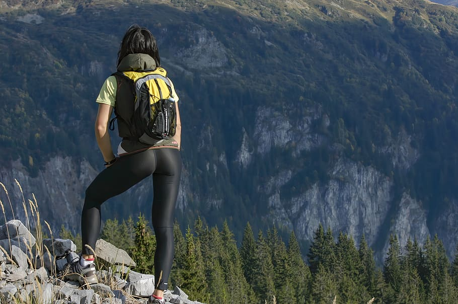 Woman standing on mountain top after hiking